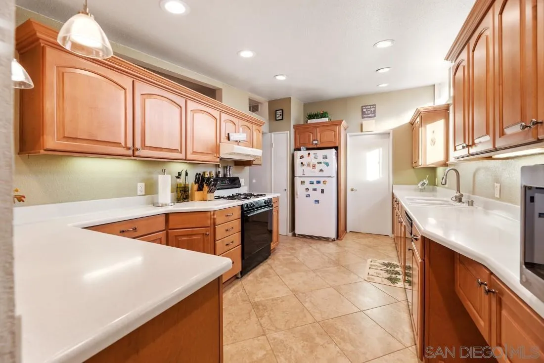 13850 Frame Road Poway, CA 92064 - Photo 19 of 44 a kitchen with stainless steel appliances granite countertop a sink stove and cabinets