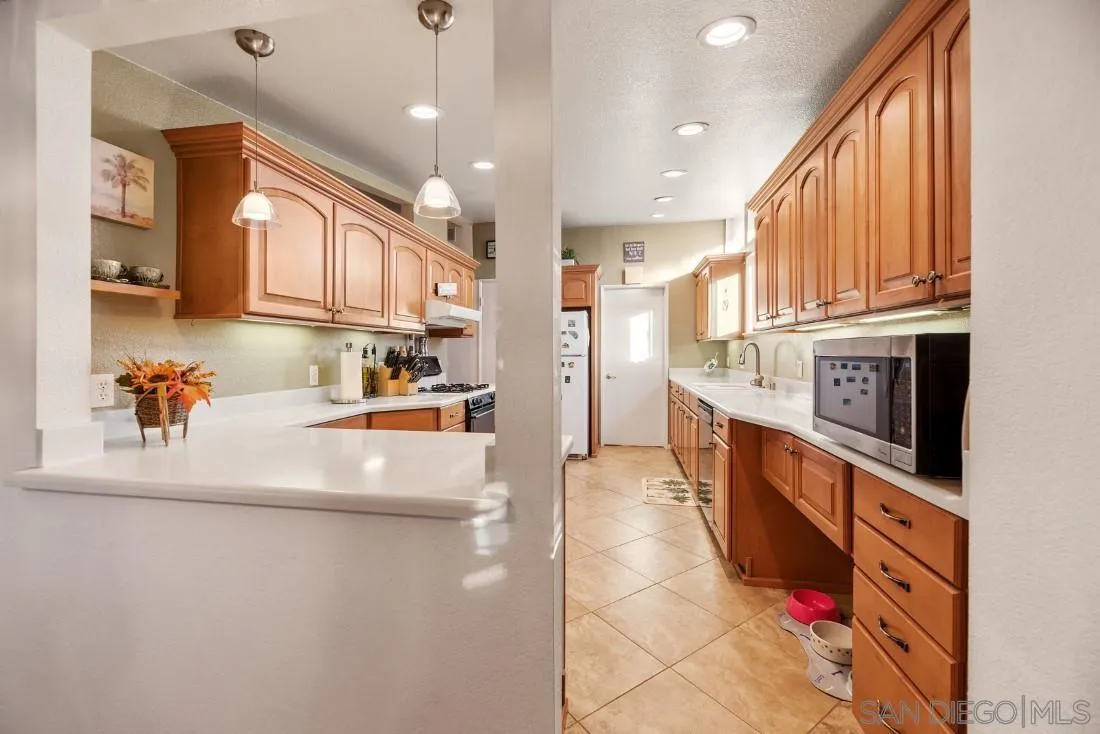13850 Frame Road Poway, CA 92064 - Photo 20 of 44 a large kitchen with stainless steel appliances granite countertop a large stove a sink and a refrigerator