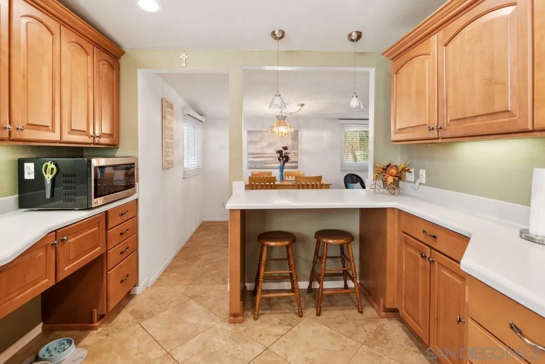 13850 Frame Road Poway, CA 92064 - Photo 21 of 44 a kitchen with stainless steel appliances a sink and cabinets