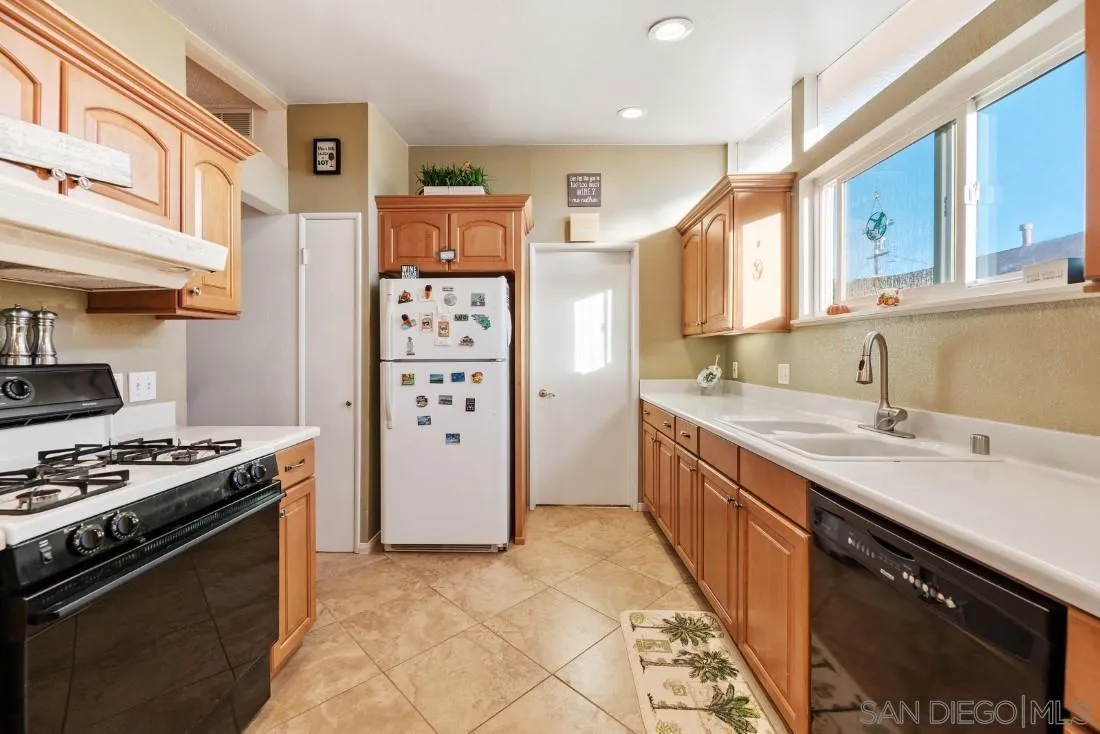 13850 Frame Road Poway, CA 92064 - Photo 22 of 44 a kitchen with stainless steel appliances a sink stove and refrigerator