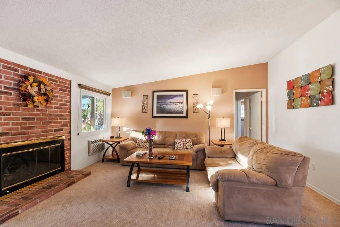 13850 Frame Road Poway, CA 92064 - Photo 24 of 44 a living room with furniture a fireplace and a flat screen tv