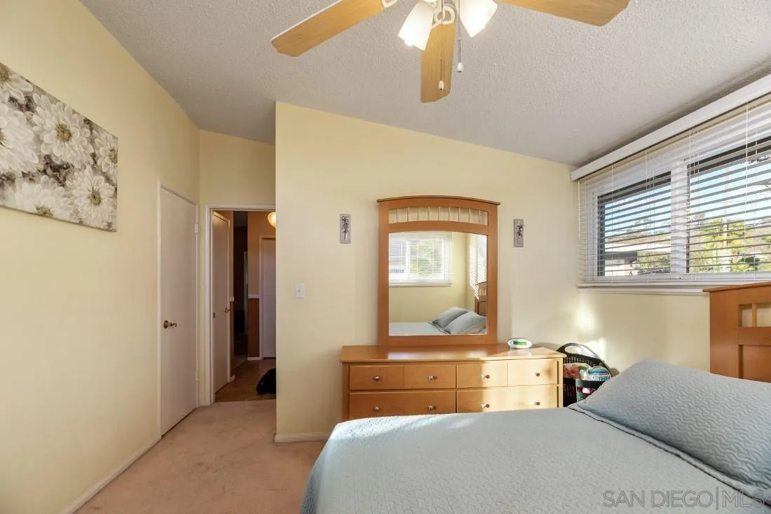 13850 Frame Road Poway, CA 92064 - Photo 34 of 44 a bedroom with a large bed and a chandelier