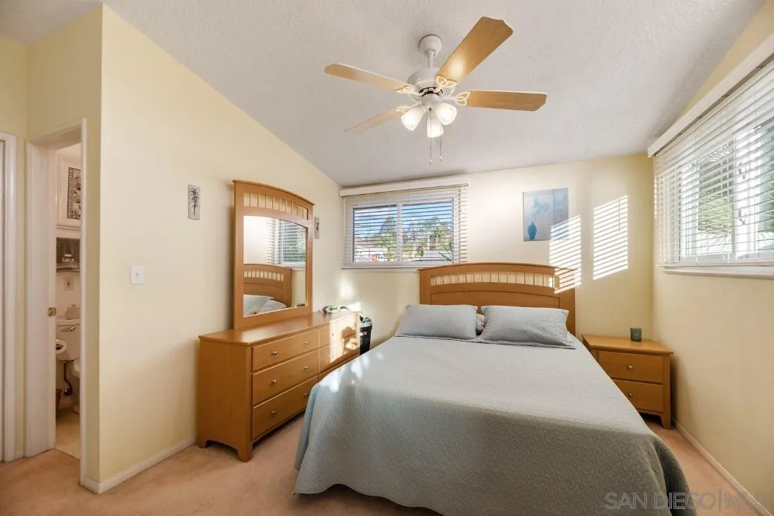13850 Frame Road Poway, CA 92064 - Photo 35 of 44 a bedroom with a large bed and a chandelier