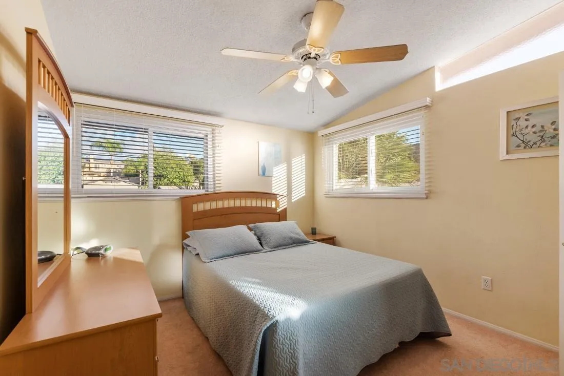 13850 Frame Road Poway, CA 92064 - Photo 36 of 44 a bedroom with a large bed and a chandelier