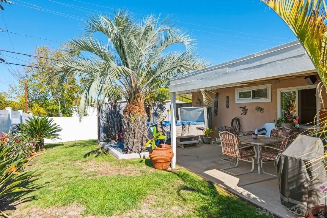 13850 Frame Road Poway, CA 92064 - Photo 42 of 44 a view of a backyard with table and chairs and a barbeque with potted plants