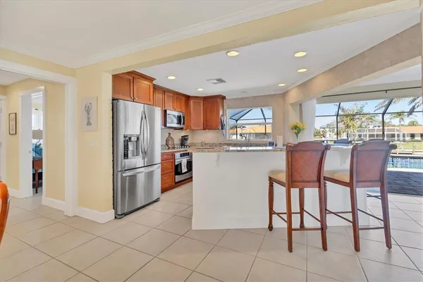 a kitchen with stainless steel appliances granite countertop a refrigerator and a stove top oven