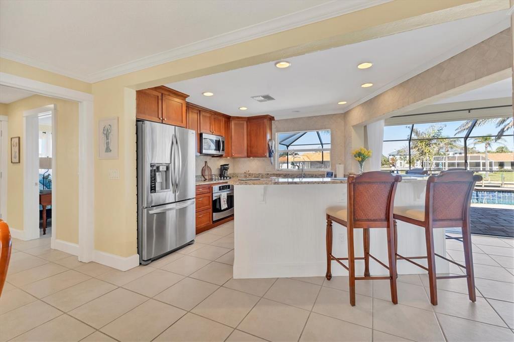 30 Buccaneer Bend Placida, FL 33946 - Photo 17 of 38 a kitchen with stainless steel appliances granite countertop a refrigerator and a stove top oven