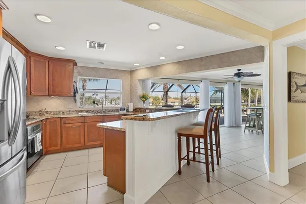 a kitchen with granite countertop a sink a counter top space appliances and cabinets