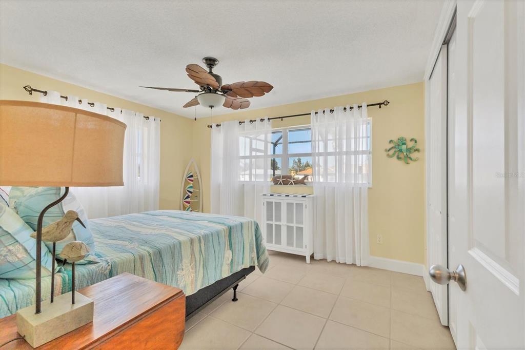 30 Buccaneer Bend Placida, FL 33946 - Photo 27 of 38 a spacious bedroom with a bed and a chandelier