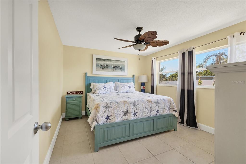 30 Buccaneer Bend Placida, FL 33946 - Photo 29 of 38 a bedroom with a bed and a chandelier