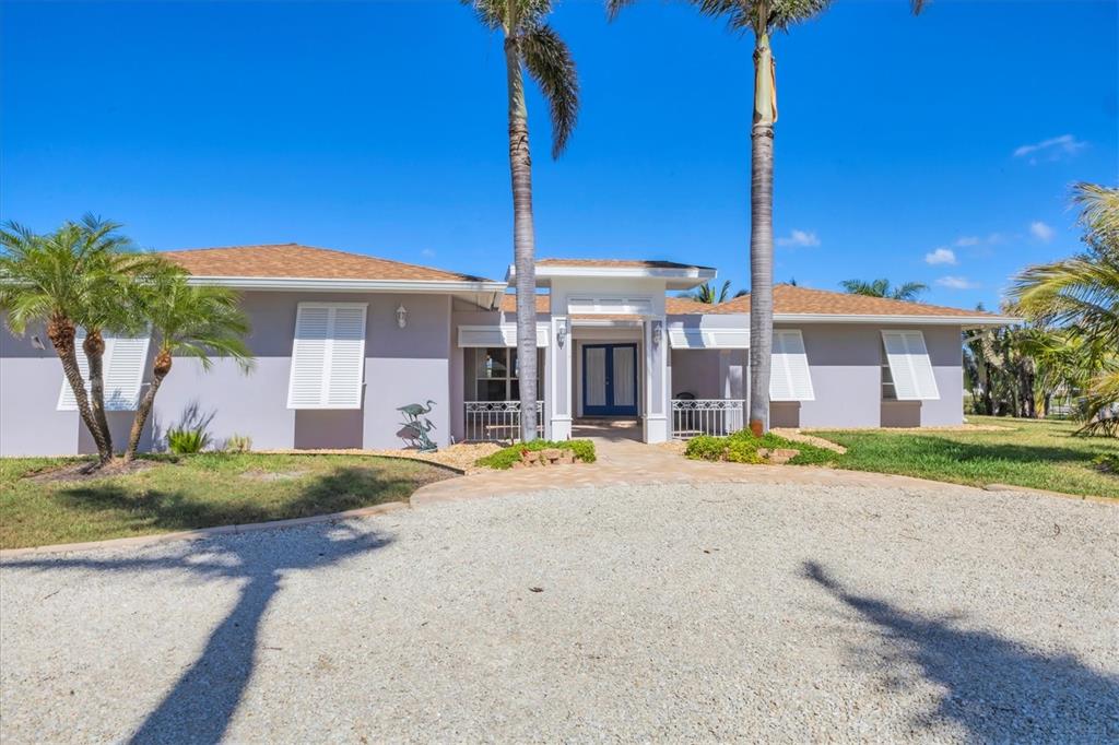 30 Buccaneer Bend Placida, FL 33946 - Photo 8 of 38 a front view of a house with a yard and garage