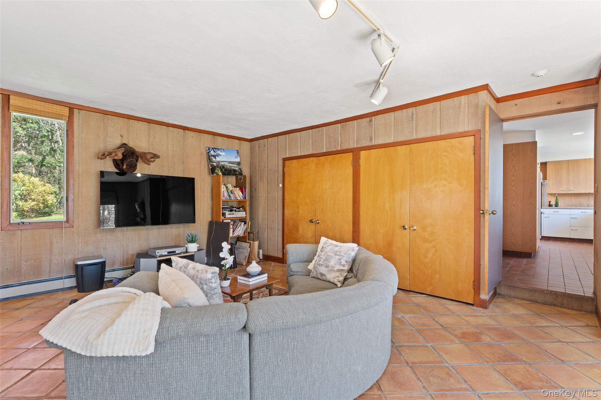 98 Cushman Road Scarsdale, NY 10583 - Photo 31 of 43 a living room with furniture and a flat screen tv