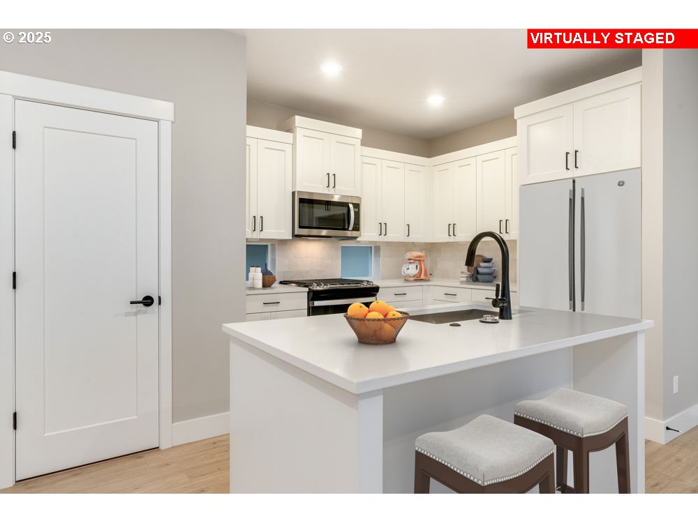 2474 North Vale Street Newberg, OR 97132 - Photo 3 of 11 a kitchen with a sink a stove cabinets and a refrigerator