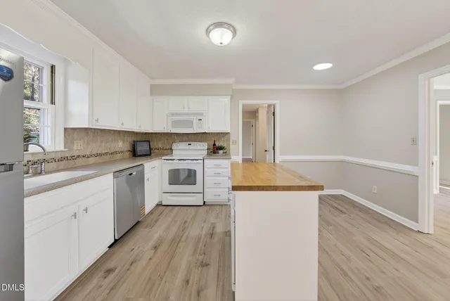 a kitchen with a sink a stove and cabinets