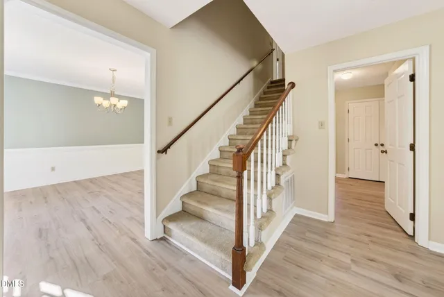 a view of a hallway view with wooden floor and staircase