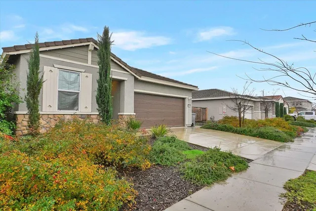 a front view of a house with garden