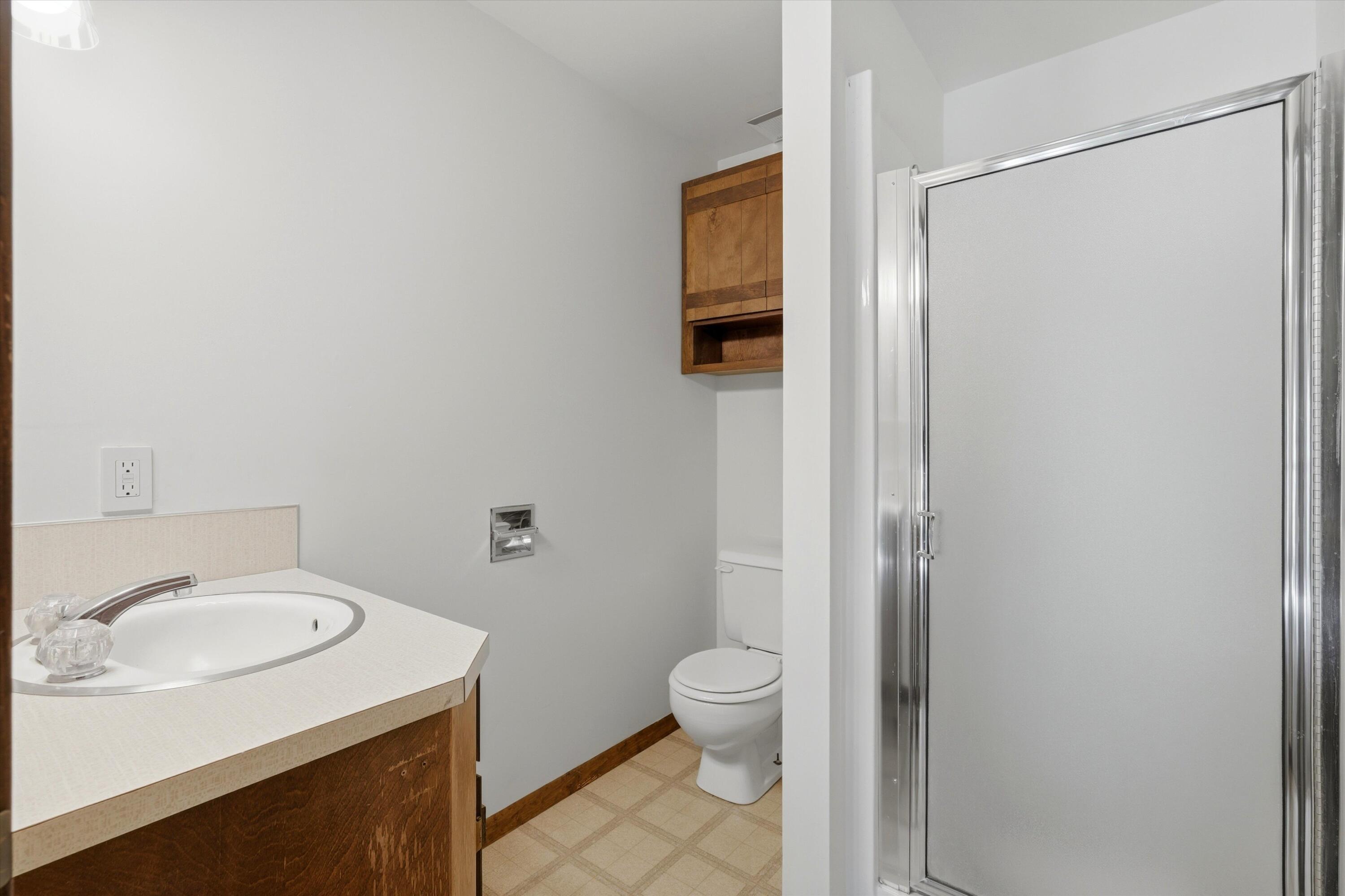 56446 Eclipse Drive Bend, OR 97707 - Photo 26 of 42 a bathroom with a sink a toilet and shower