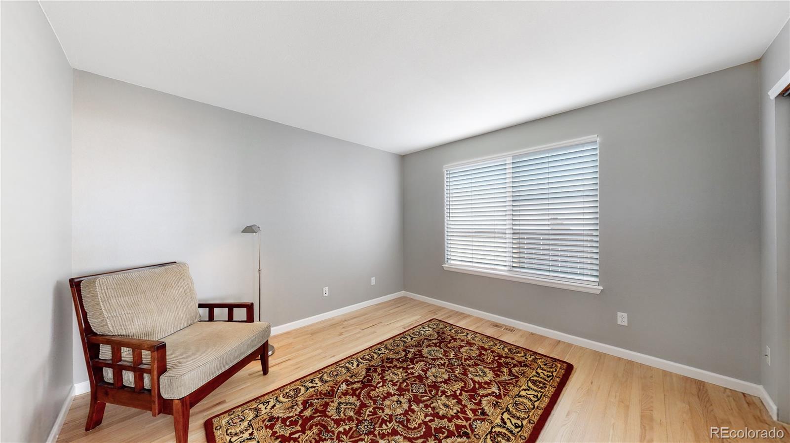 4841 Tarcoola Lane Highlands Ranch, CO 80130 - Photo 11 of 39 a view of a room with furniture and wooden floor
