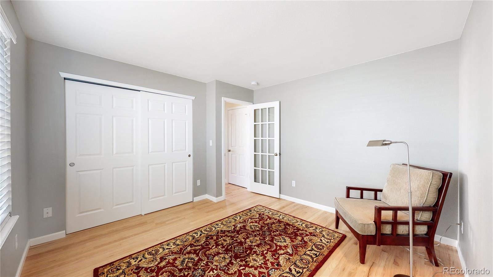 4841 Tarcoola Lane Highlands Ranch, CO 80130 - Photo 12 of 39 a bedroom with a bed and a chair