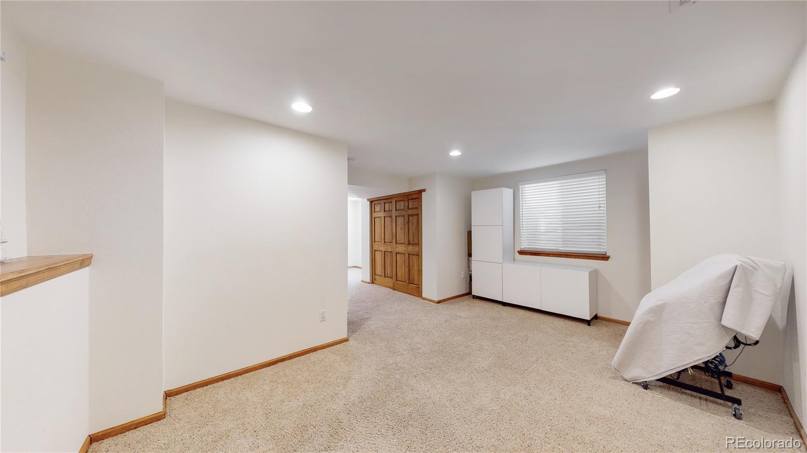4841 Tarcoola Lane Highlands Ranch, CO 80130 - Photo 15 of 39 a view of a livingroom with furniture and a window