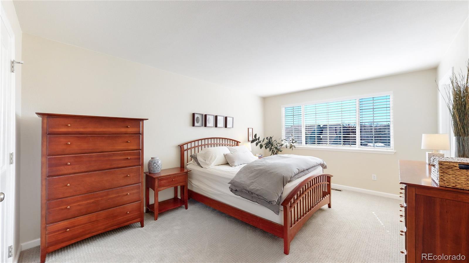 4841 Tarcoola Lane Highlands Ranch, CO 80130 - Photo 18 of 39 a bedroom with a bed and a dresser