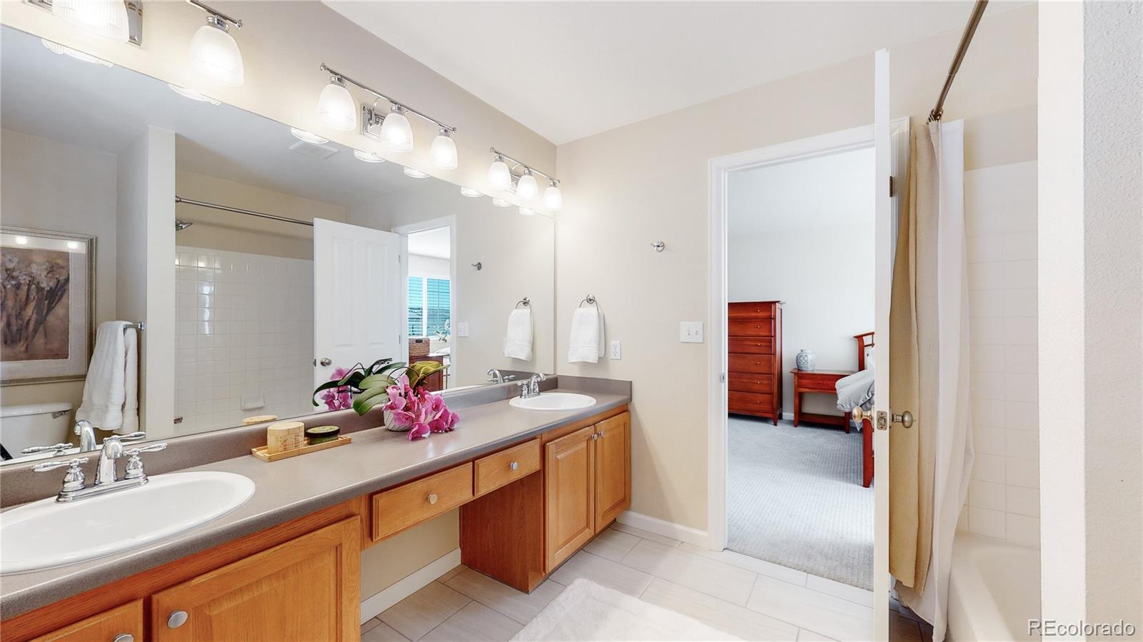 4841 Tarcoola Lane Highlands Ranch, CO 80130 - Photo 20 of 39 a spacious bathroom with a sink double vanity and a mirror