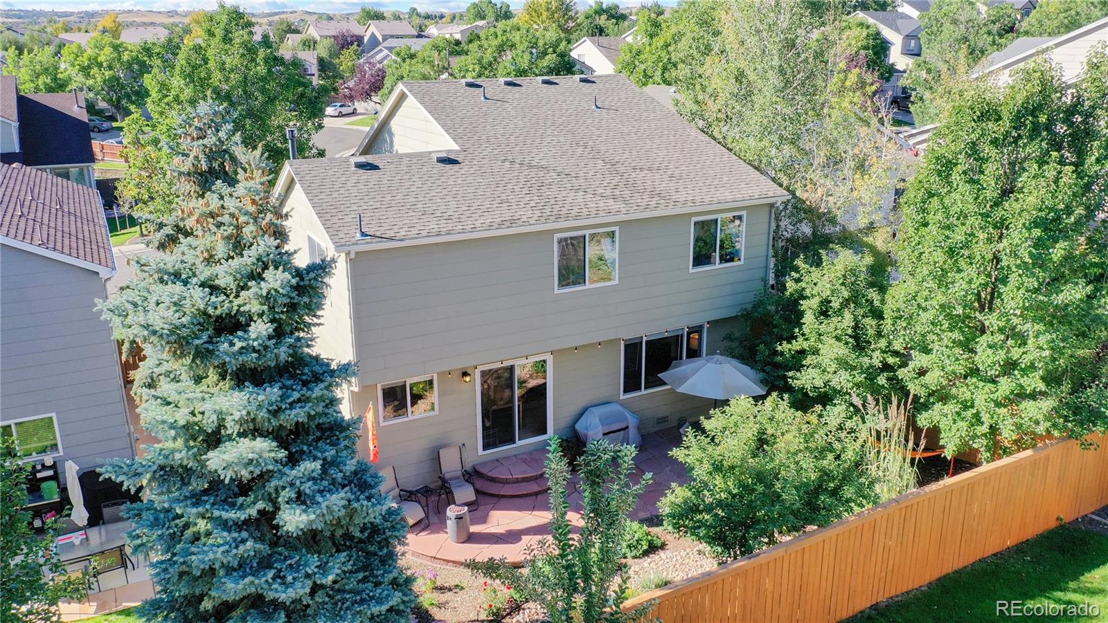 4841 Tarcoola Lane Highlands Ranch, CO 80130 - Photo 27 of 39 aerial view of a house with a yard and potted plants