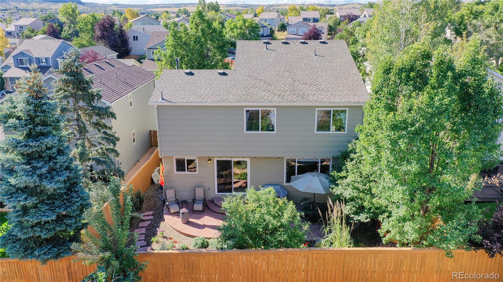 4841 Tarcoola Lane Highlands Ranch, CO 80130 - Photo 28 of 39 an aerial view of a house with yard and outdoor seating