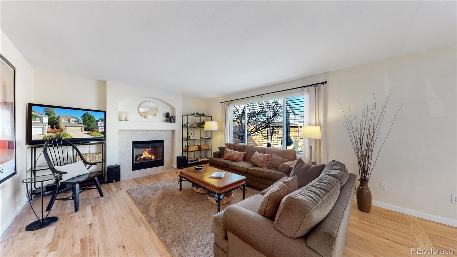 4841 Tarcoola Lane Highlands Ranch, CO 80130 - Photo 3 of 39 a living room with furniture and a fireplace