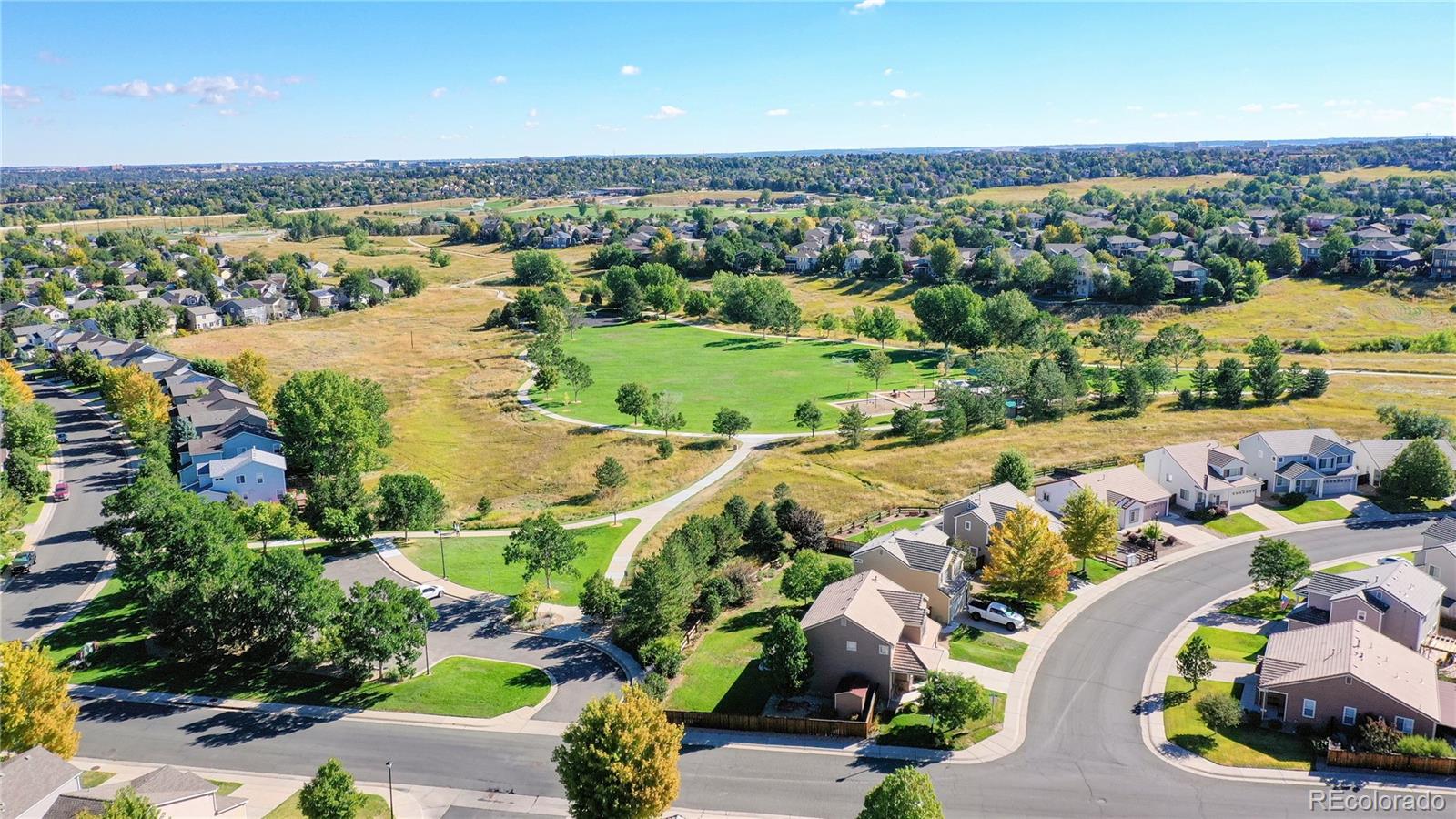 4841 Tarcoola Lane Highlands Ranch, CO 80130 - Photo 34 of 39 an aerial view of a house with a lake view