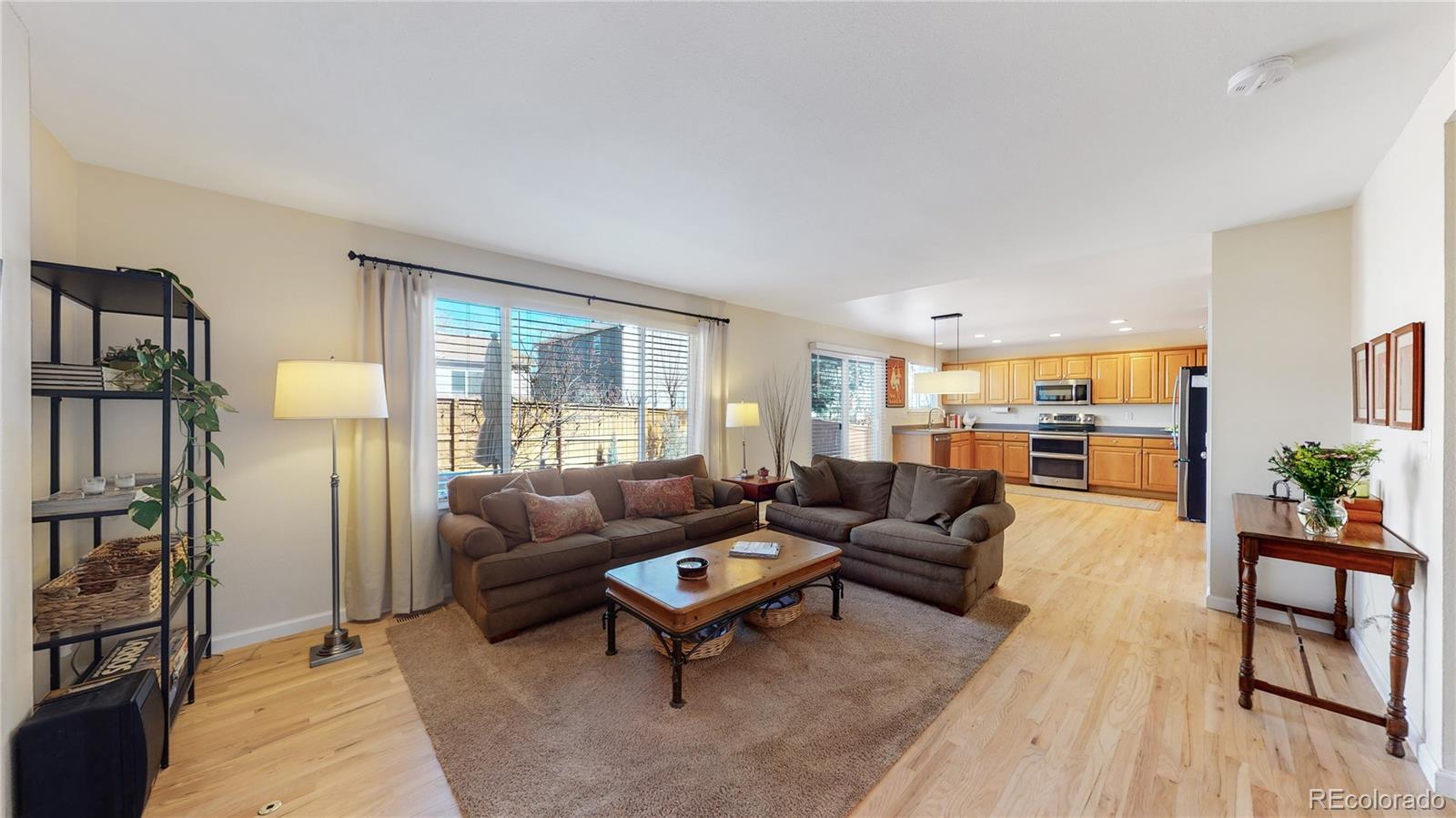 4841 Tarcoola Lane Highlands Ranch, CO 80130 - Photo 4 of 39 a living room with furniture and a large window