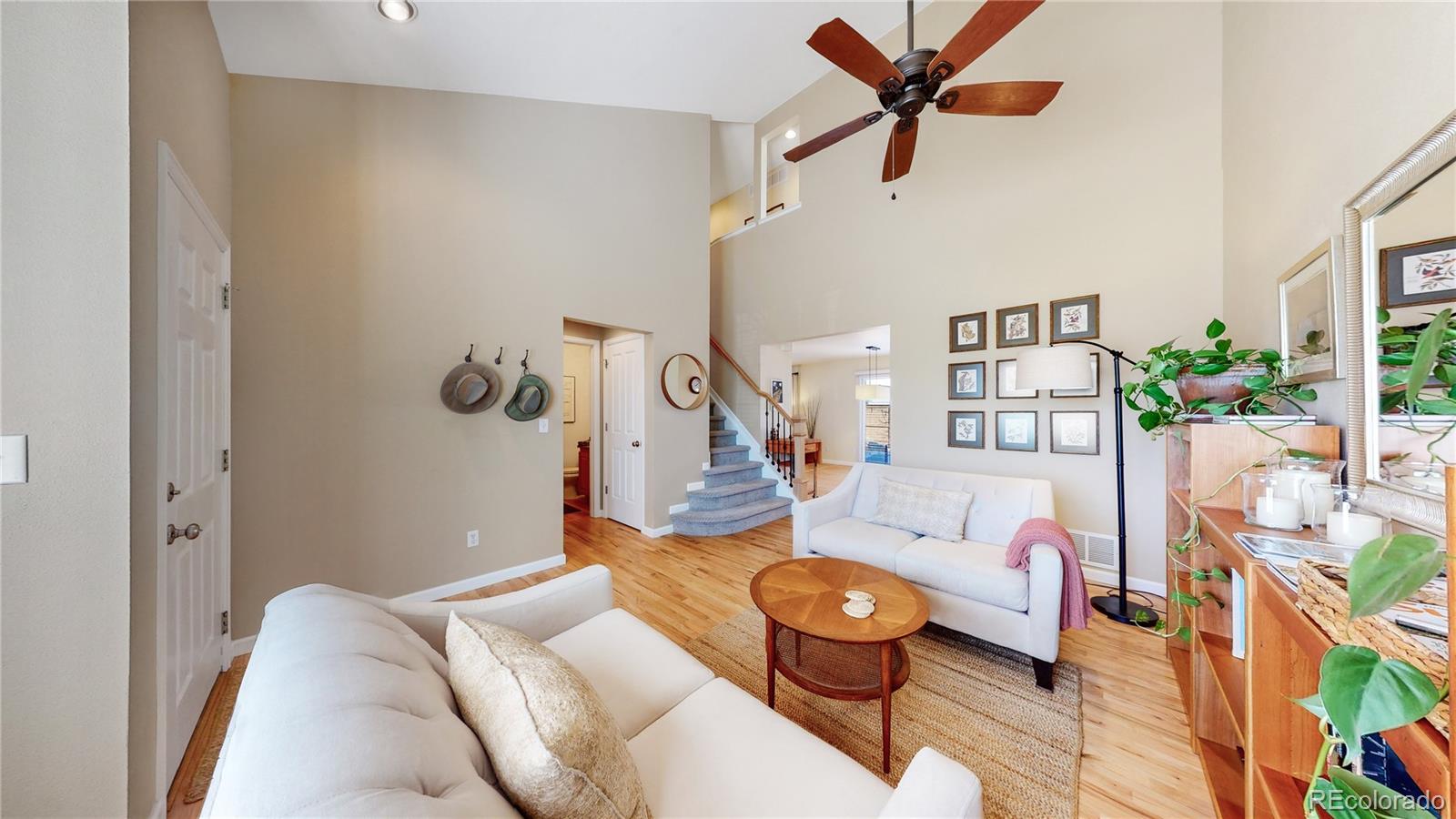 4841 Tarcoola Lane Highlands Ranch, CO 80130 - Photo 9 of 39 a living room with furniture and a chandelier