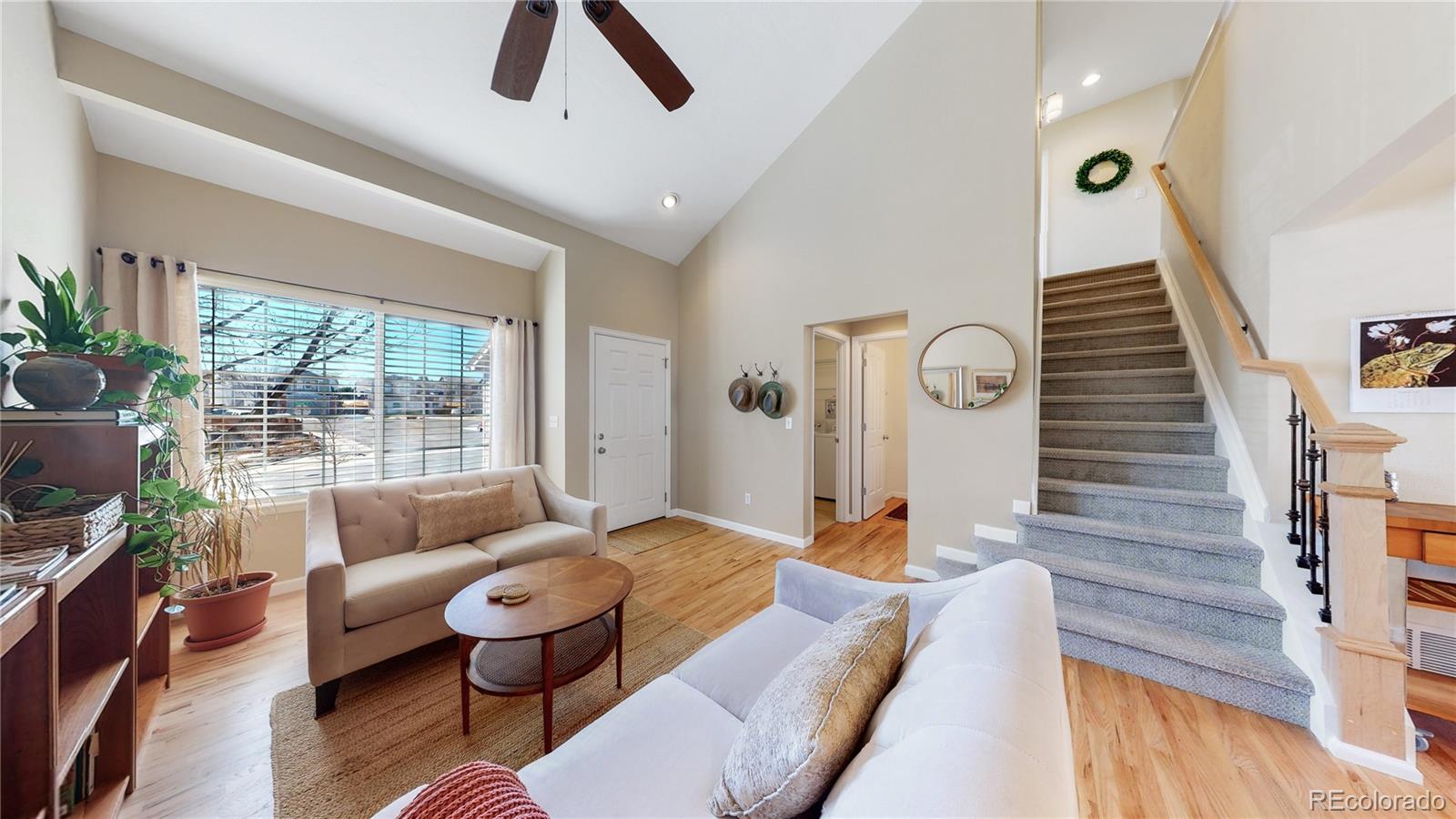 4841 Tarcoola Lane Highlands Ranch, CO 80130 - Photo 10 of 39 a living room with furniture and a large window