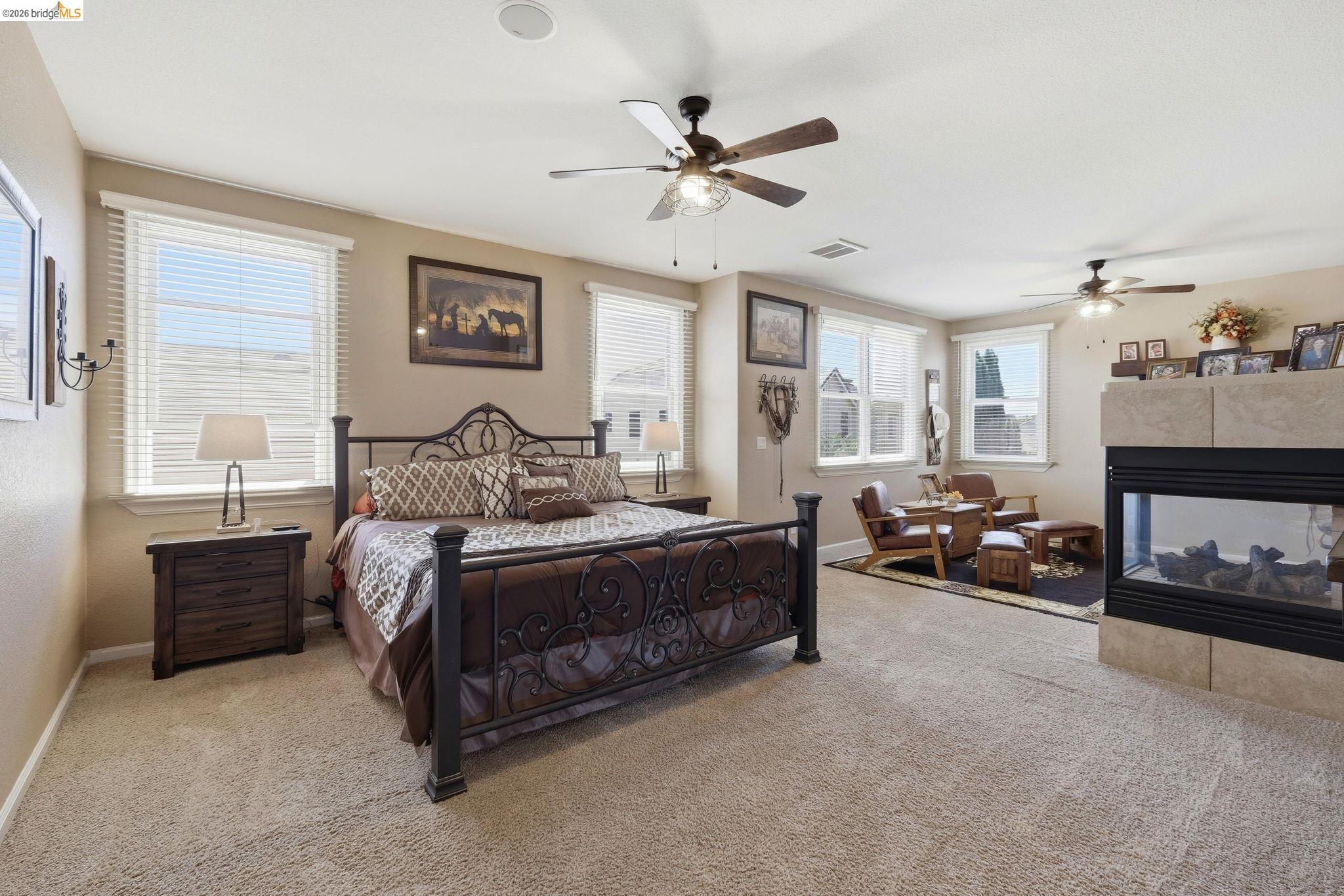 3438 Keystone Loop Discovery Bay, CA 94505 - Photo 21 of 57 a spacious bedroom with a bed and a chandelier