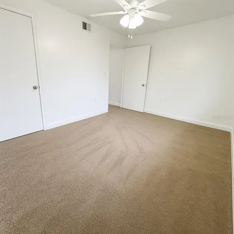 a view of an empty room with a fan