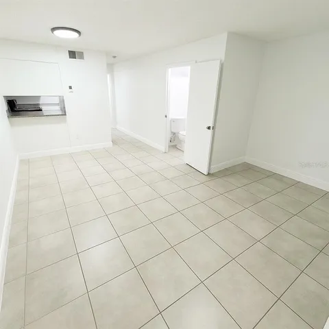 an empty room with white walls and tiles