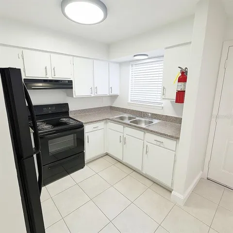 a kitchen with granite countertop cabinets and white appliances
