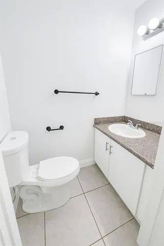 a white toilet sitting next to a bathroom sink
