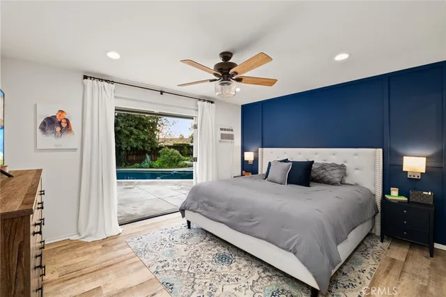 a bedroom with a large bed and a chandelier