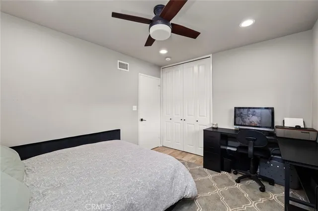 a bedroom with a bed and a desk