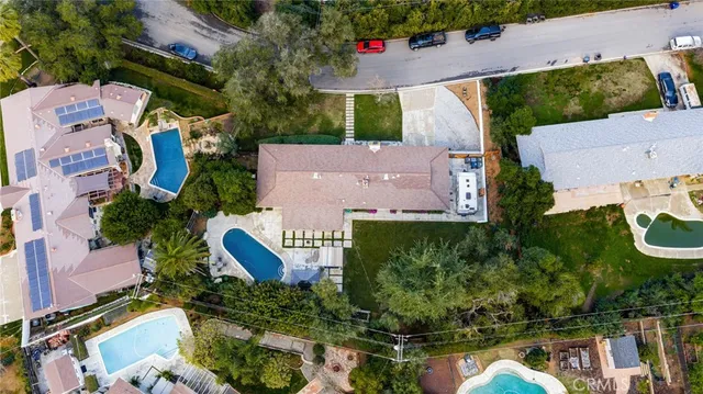 an aerial view of house with yard swimming pool and outdoor seating