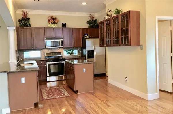 a kitchen with stainless steel appliances a stove a sink and a refrigerator