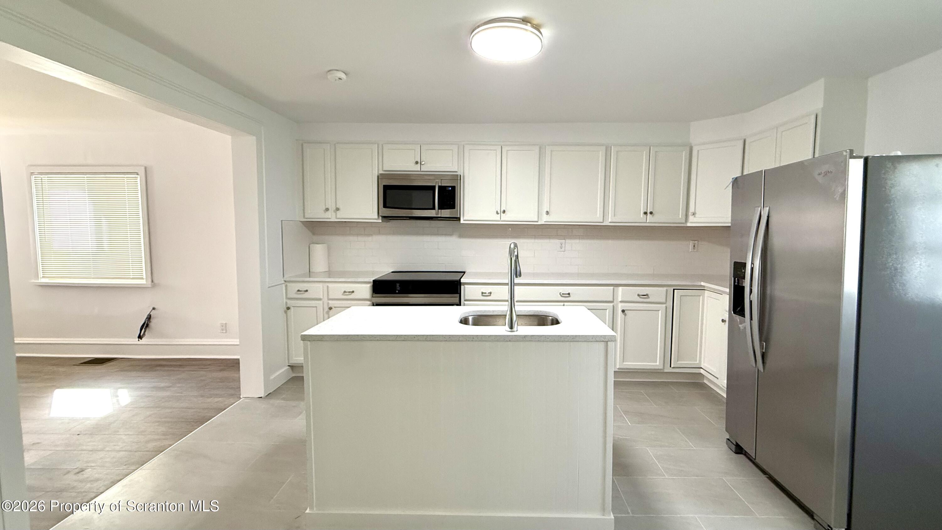 1032 Chestnut Street Sunbury, PA 17801 - Photo 4 of 25 a kitchen with cabinets and stainless steel appliances