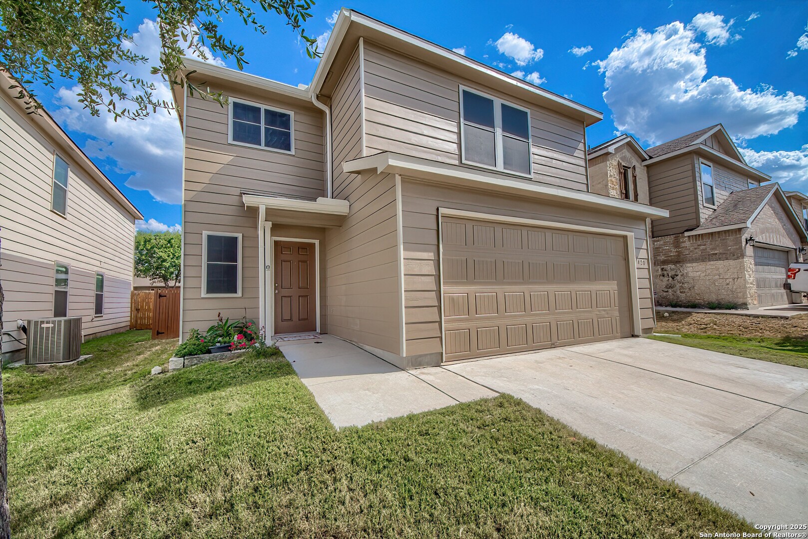 a front view of a house with a yard and garage