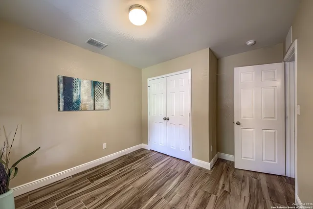 wooden floor in an empty room with a window