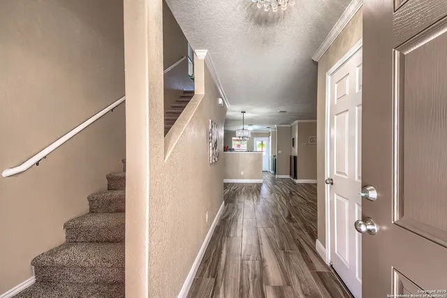 a view of entryway and hall with wooden floor