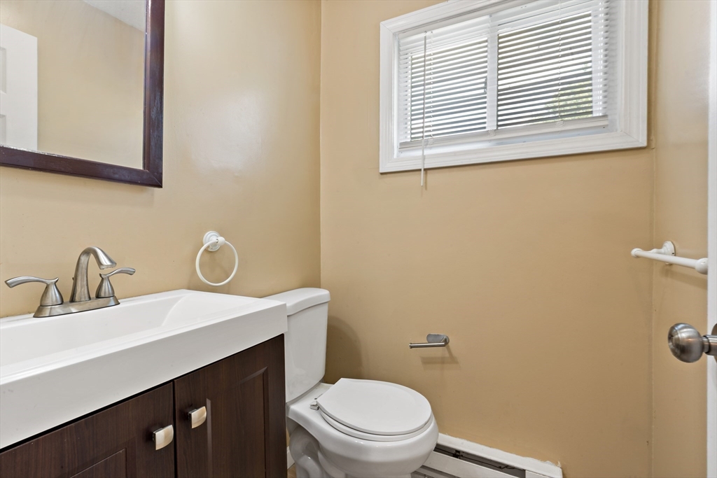 45 Fourth Street Worcester, MA 01602 - Photo 6 of 21 a bathroom with a sink a toilet and a mirror