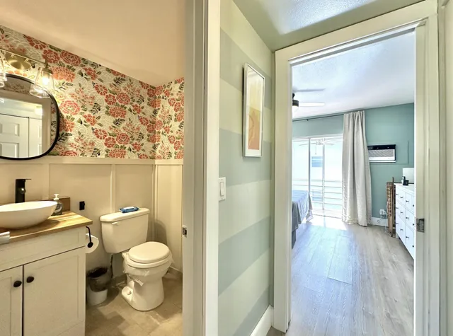 a bathroom with a granite countertop sink toilet and shower