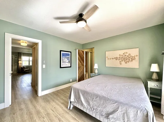 a bedroom with a bed and a lamp on table