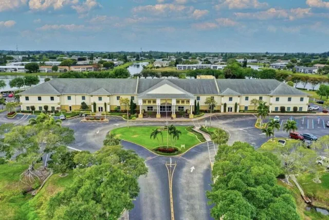 an aerial view of residential houses with outdoor space and lake view